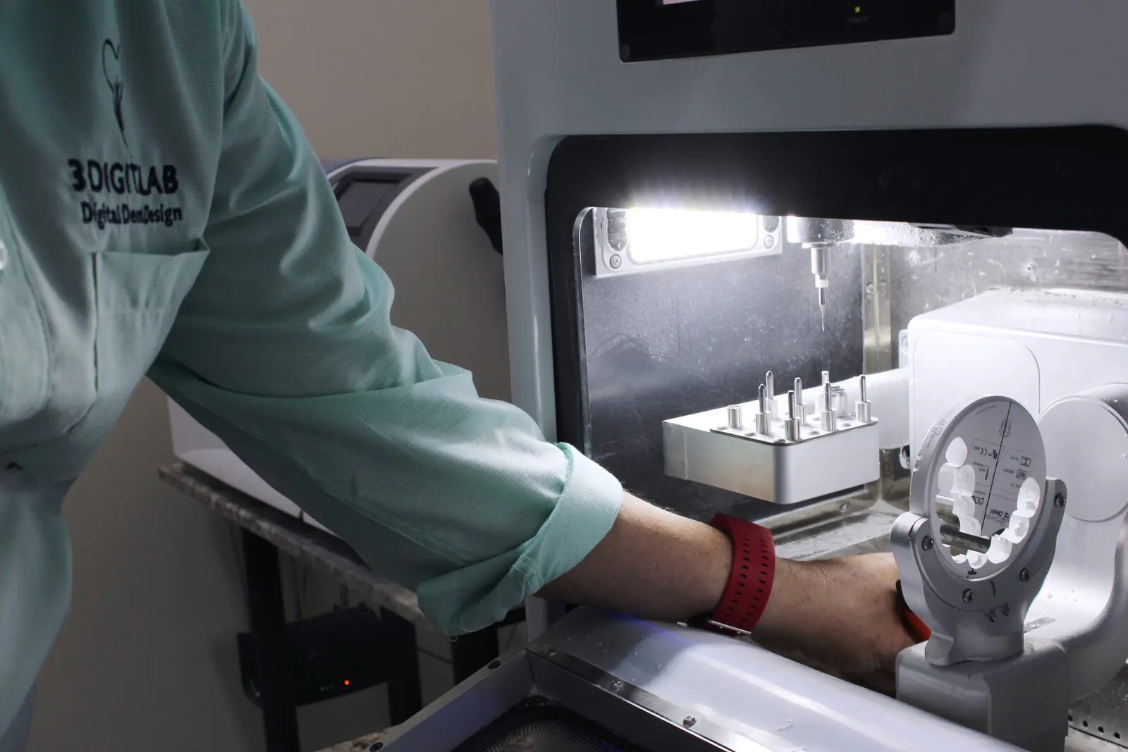 Technician loading tools into the lab CAD/CAM mill