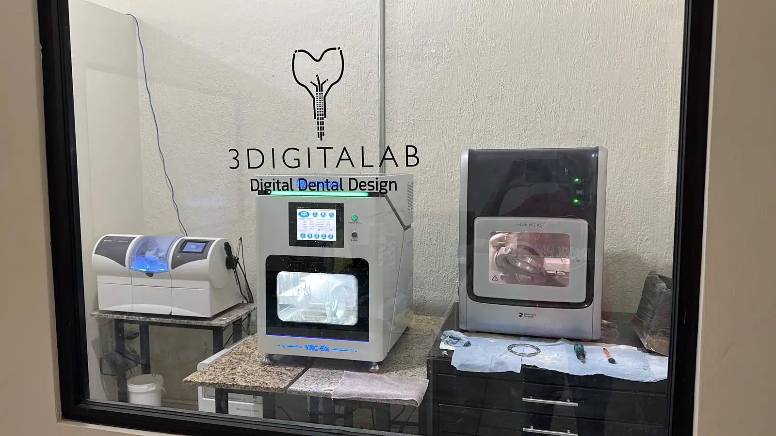 3DigitaLab CAD/CAM machine room: mills and sintering furnace behind glass